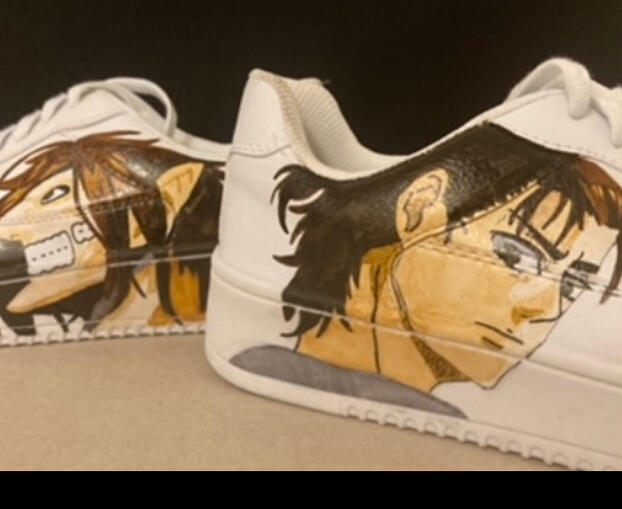 Eren Jaegar in his Titan form on the shoe in the background. Foreground shoe is him in his human form.
